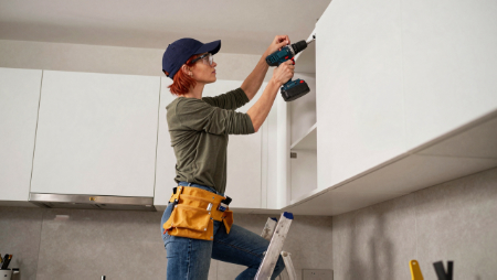 female contractor standing on ladder installing kitchen cabinet generated with Z-Image